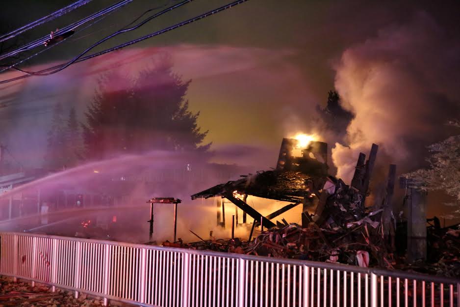 Last Cut East Barber shop in flames after explosion. Photo by Dave Lindstedt
