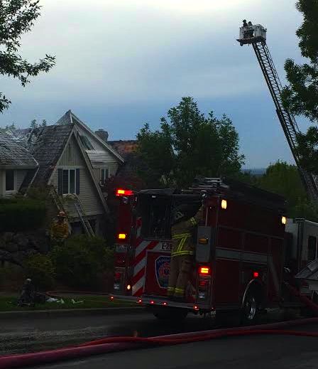 Snoqualmie firefighter keeping close watch on Fairway Ave burnt home, 7/4/14. Pic: Carol Kerr