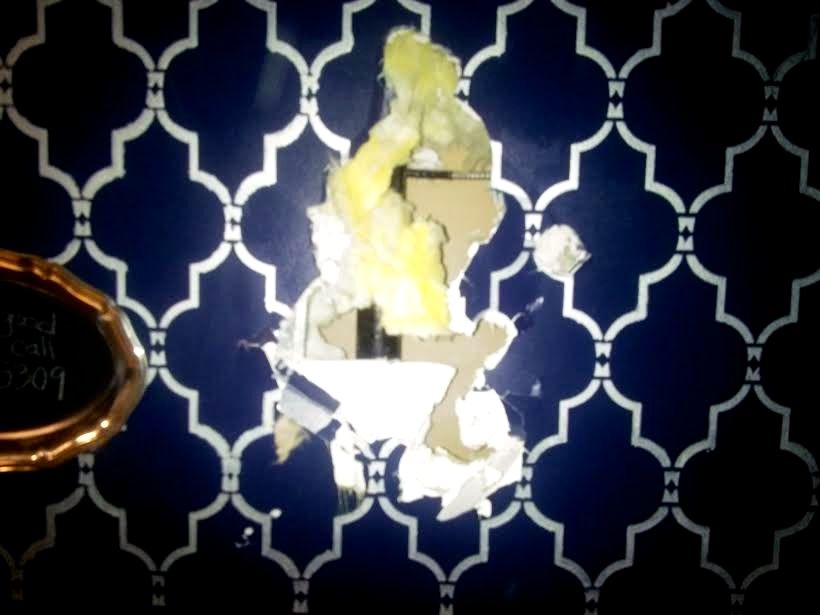 Hole hammered in Lula Ruby restroom wall where a water pipe was struck. Photo: Angela Favero