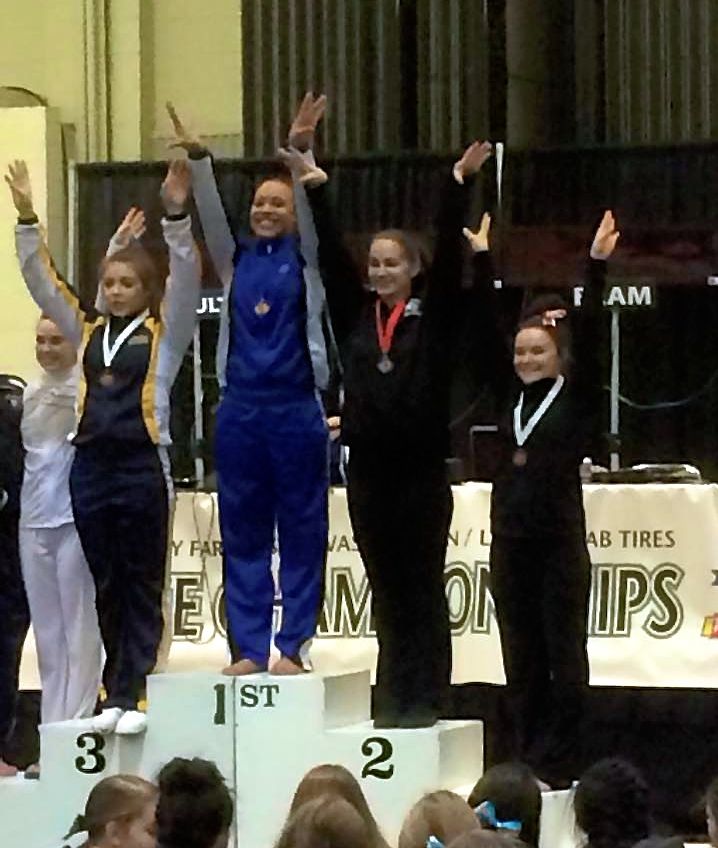 Jenn Rodgers, far right, finished 4th in the State 4A All-Around Gymnastics Final.