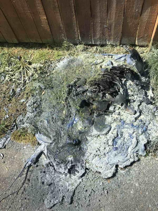 Remnants of melted recycle can on Fern Ave after fire destroyed it on 4/29/16.