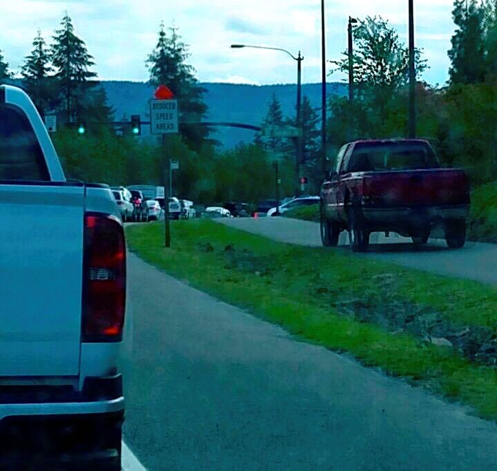 Driver attempting to avoid traffic backups by driving on Snoqualmie Pkwy walking path near Jacobia Street, 7/15/16
