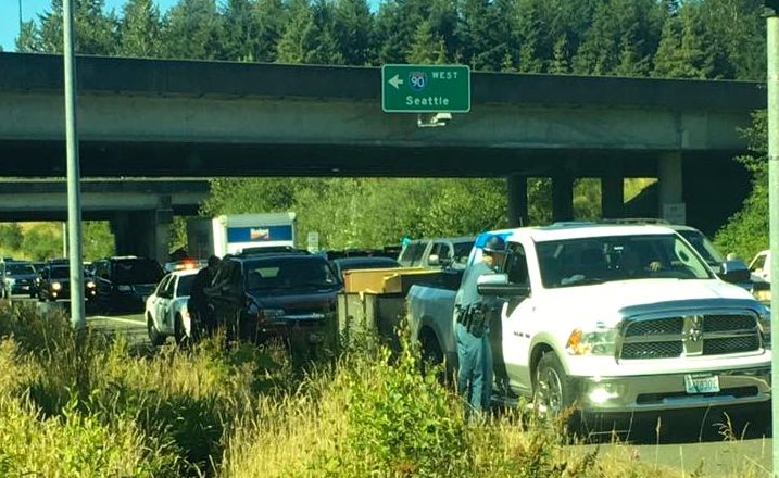 Trooper addressing a driver at he 90/18 interchange the week after a fiery collision nearly took a woman's life near exit 25.
